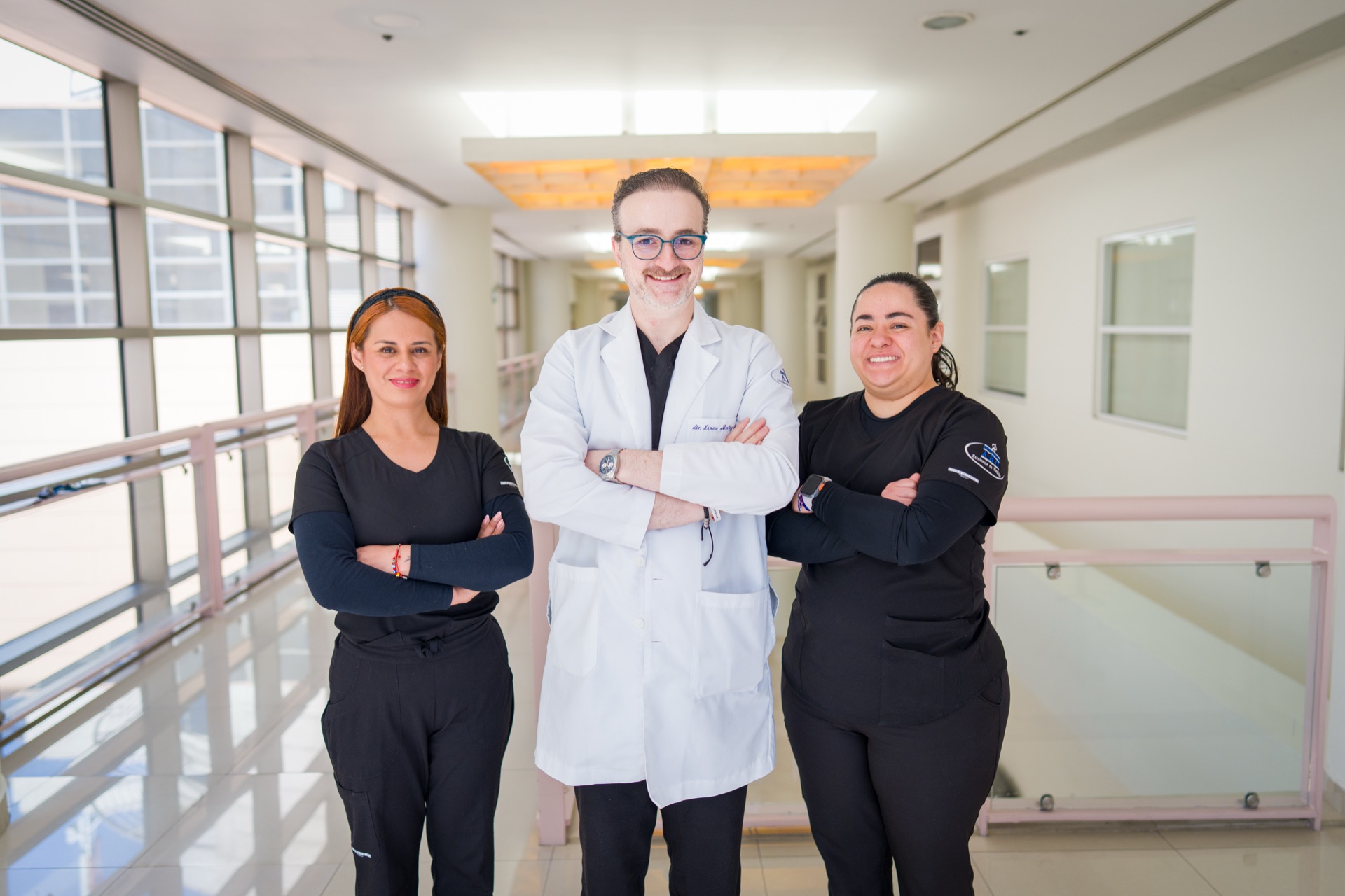 Dr. Isaac Baley with his clinical team in a hospital corridor